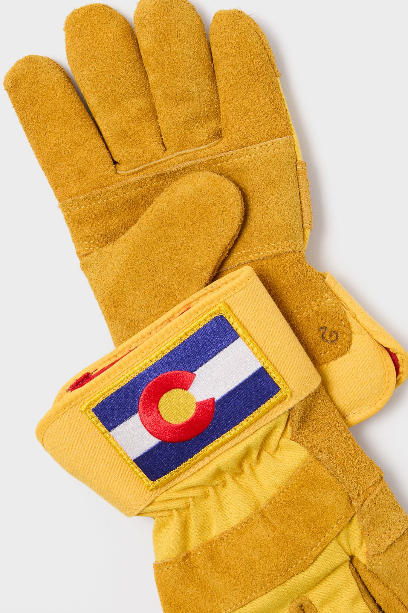 Colorado Gloves: Classic, high-end yellow suede work gloves with waterproofing, insulated for cold weather. Features a fun Colorado flag patch on the cuff for effortless style.