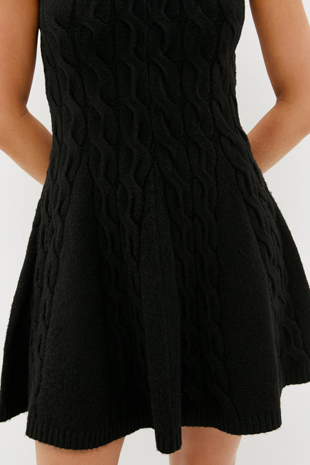 Black Cable Knit Mini Saxon Dress with a classic, effortless fit-and-flare silhouette, featuring a fun, textured cable pattern and high-end ribbed finishes, perfect for any occasion.