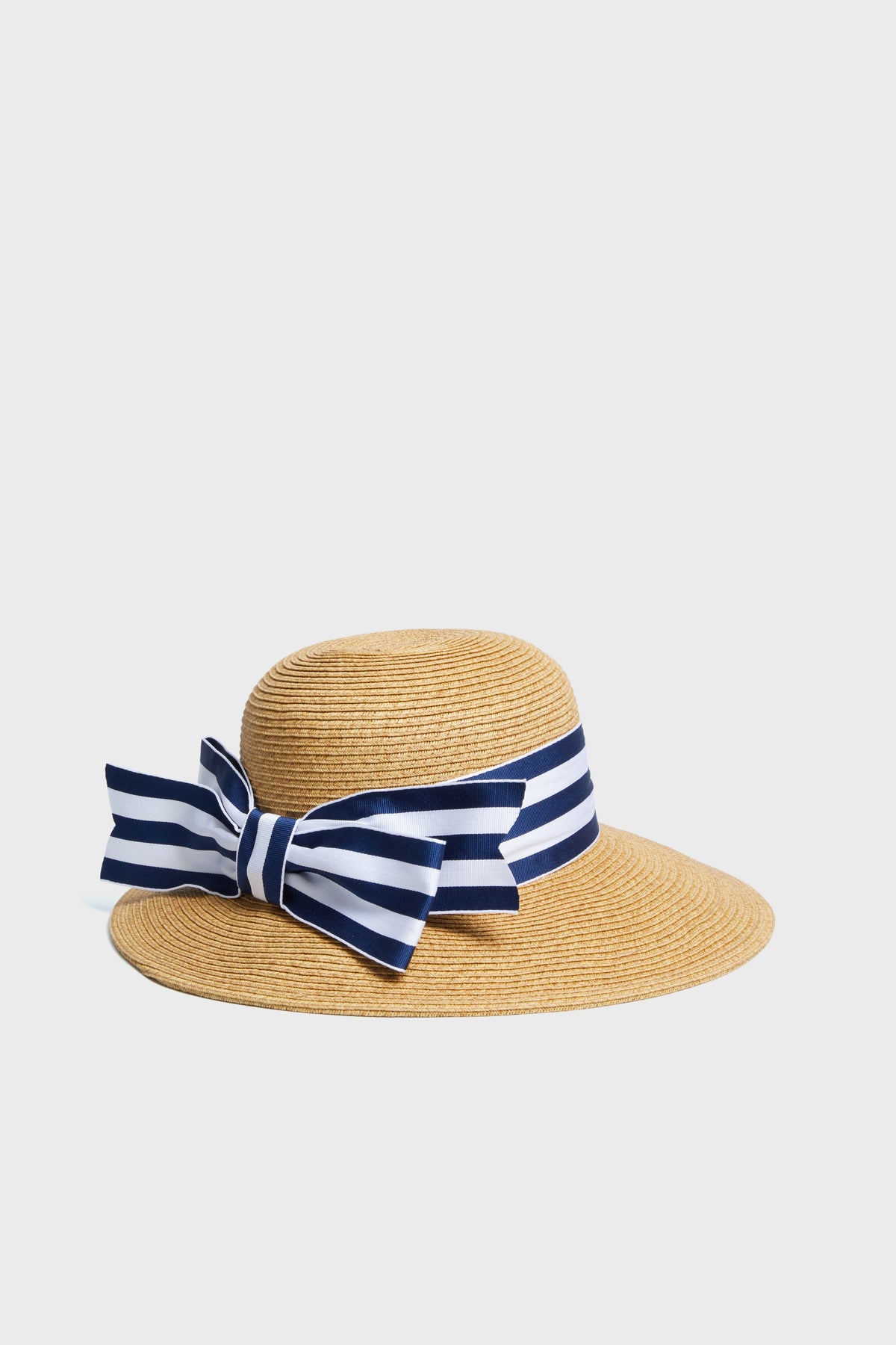 Toucan Hats wide-brimmed straw hat with a navy and white striped ribbon bow offers stylish sun protection. This packable accessory is perfect for your beach collection.