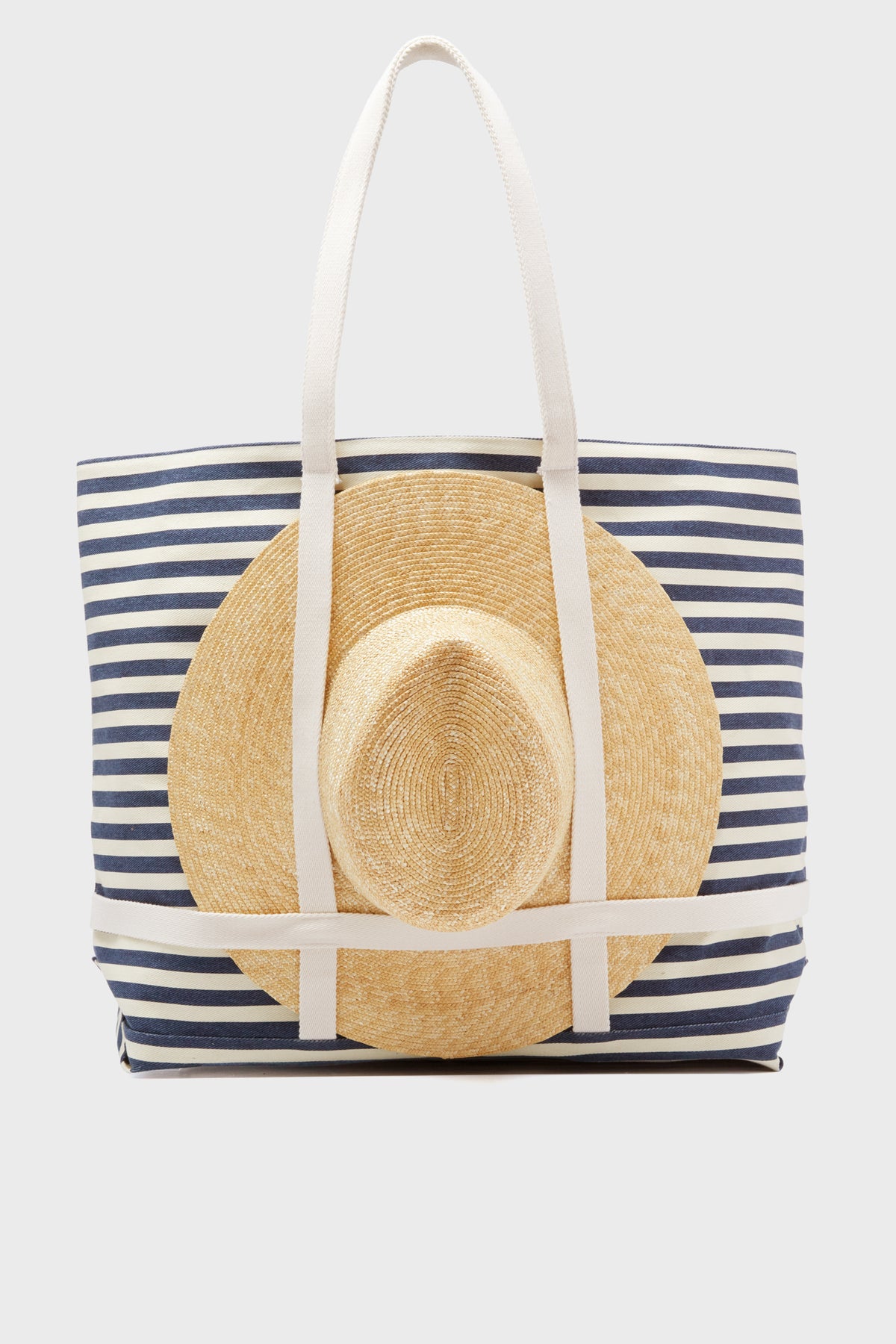 The Hat Attack Navy Striped Sunhat Tote includes a stylish packable straw hat, making it the ideal travel beach tote.