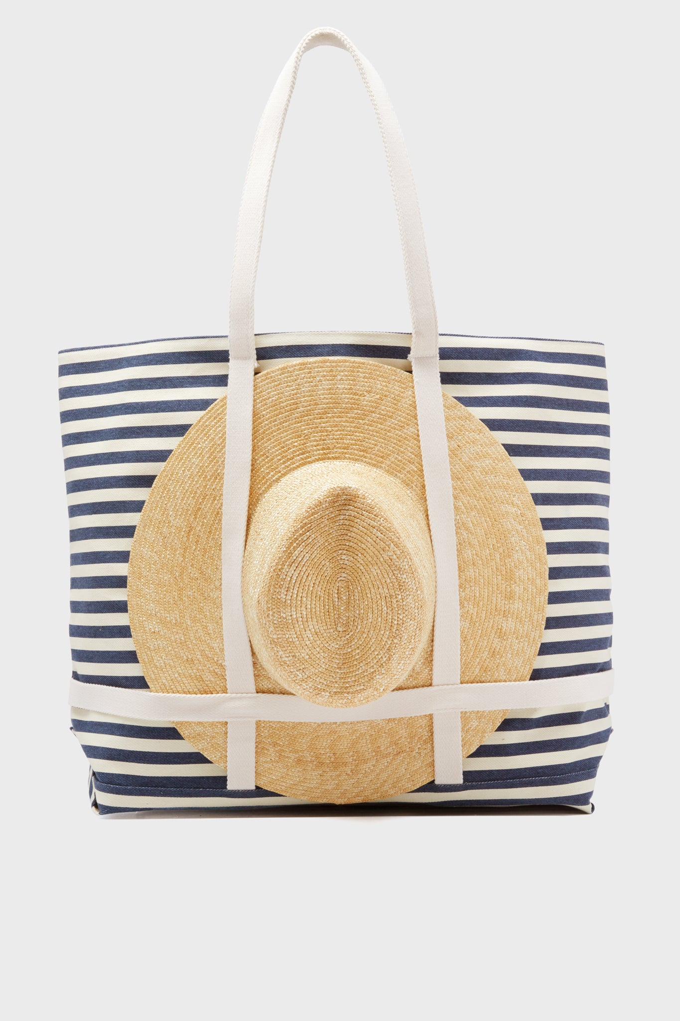 The Hat Attack Navy Striped Sunhat Tote includes a stylish packable straw hat, making it the ideal travel beach tote.