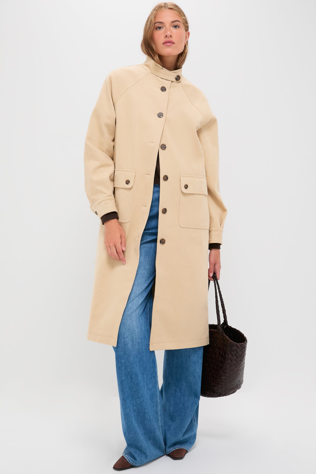Model wearing the classic Beige and Navy Oakley Coat, paired with wide-leg jeans and brown shoes, exuding effortless, high-end style.