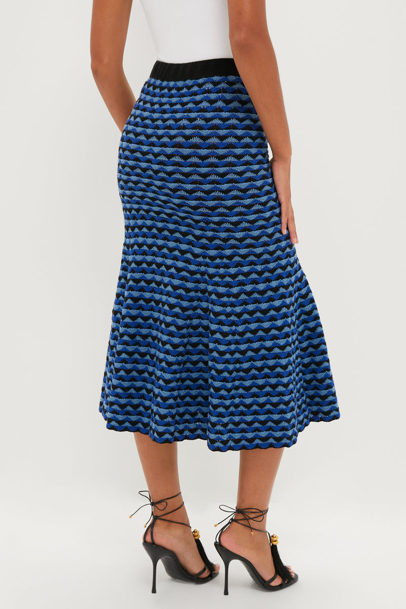 Blue and Black Profundo Midi Skirt showcasing a classic, flared silhouette with a fun zigzag pattern, styled effortlessly with high-end strappy black sandals.