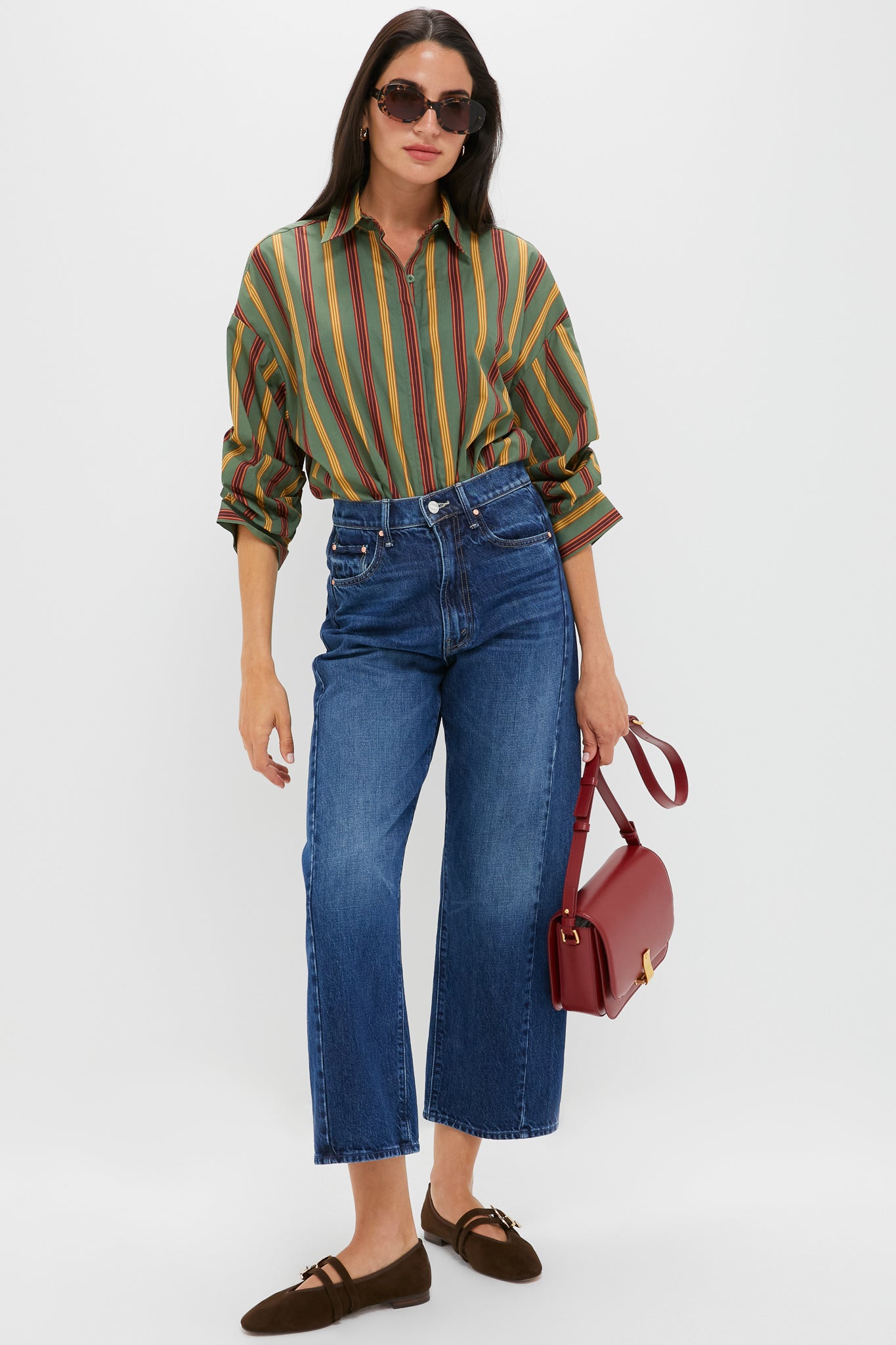 Model wearing Chocolate Suede Buckle Nina Flats—classic Mary-Jane style with gold buckles, paired effortlessly with cropped jeans and a structured shoulder bag for a high-end, fun look.