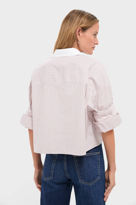 Back view of a person wearing the Spanish Villa and White Next Ex Shirt, a classic, effortless, cropped button-down with rolled sleeves, paired with high-waisted jeans.