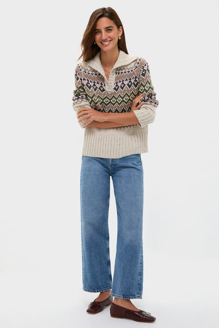 A woman smiles in a Hyacinth House relaxed fit sweater, wide-leg blue jeans, and brown flats against a plain white background.