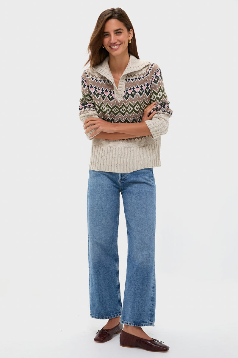 A woman smiles in a Hyacinth House relaxed fit sweater, wide-leg blue jeans, and brown flats against a plain white background.