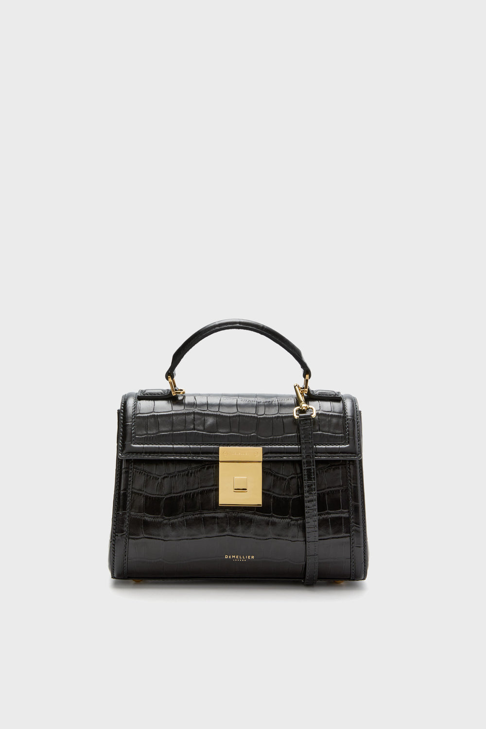 The Demellier Black Croc Paris Bag, handcrafted from sustainable Italian leather, features a top handle, gold square clasp, and a detachable shoulder strap.
