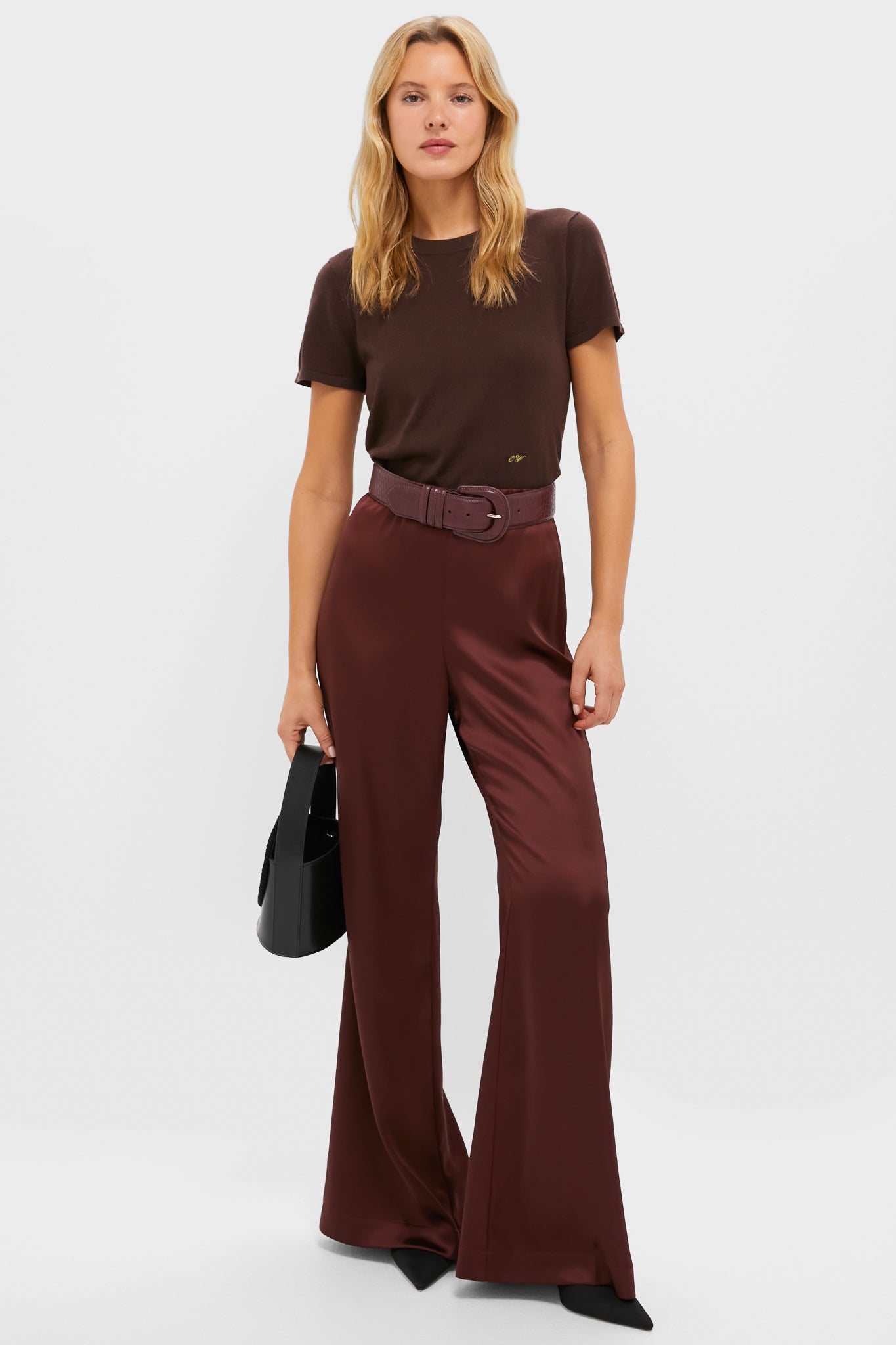 Model showcasing the Oxblood Croc-Embossed Waist Belt, cinching burgundy satin trousers, epitomizing an effortless, high-end style with classic elegance and fun flair.