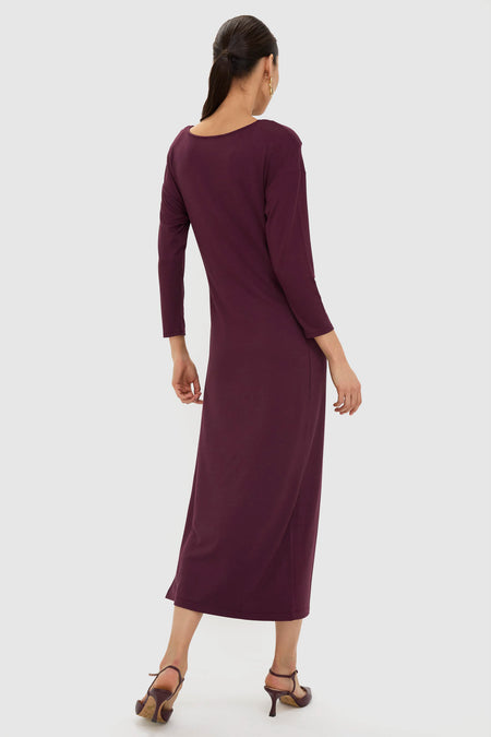 Woman models the Winetasting Side Tie Elspeth Maxi Dress, showcasing an effortless, classic silhouette with a scooped back and faux wrap detail, highlighting its high-end, fun style.