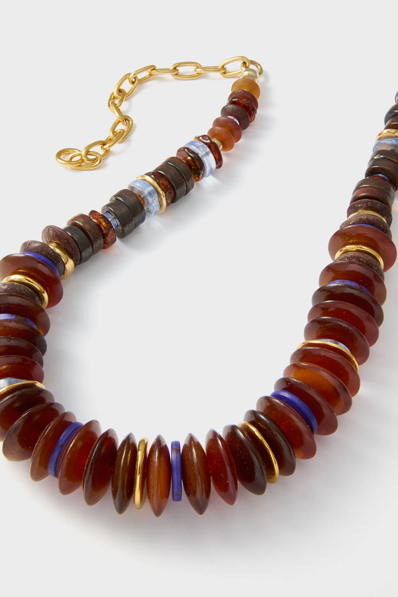Multi Amaranth Necklace: A classic, high-end beaded piece with translucent amber-like discs, vibrant blue, and gold spacers, featuring an adjustable gold-tone chain for effortless, fun styling.