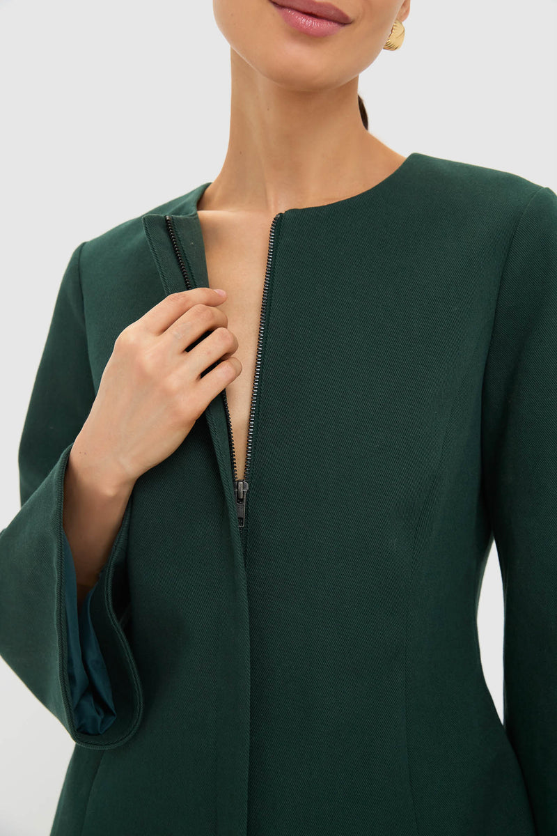 Woman unzipping the classic Garden Scrollwork Jacquard Belted Rhoda Tunic Top, showcasing its effortless, high-end design with tailored seams and balloon sleeves for a fun, polished look.