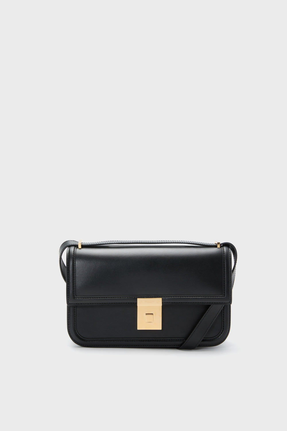 A Black Demellier Paris Shoulder Bag featuring a gold rectangular clasp and long strap, handcrafted from sustainable Italian leather for a luxurious touch.