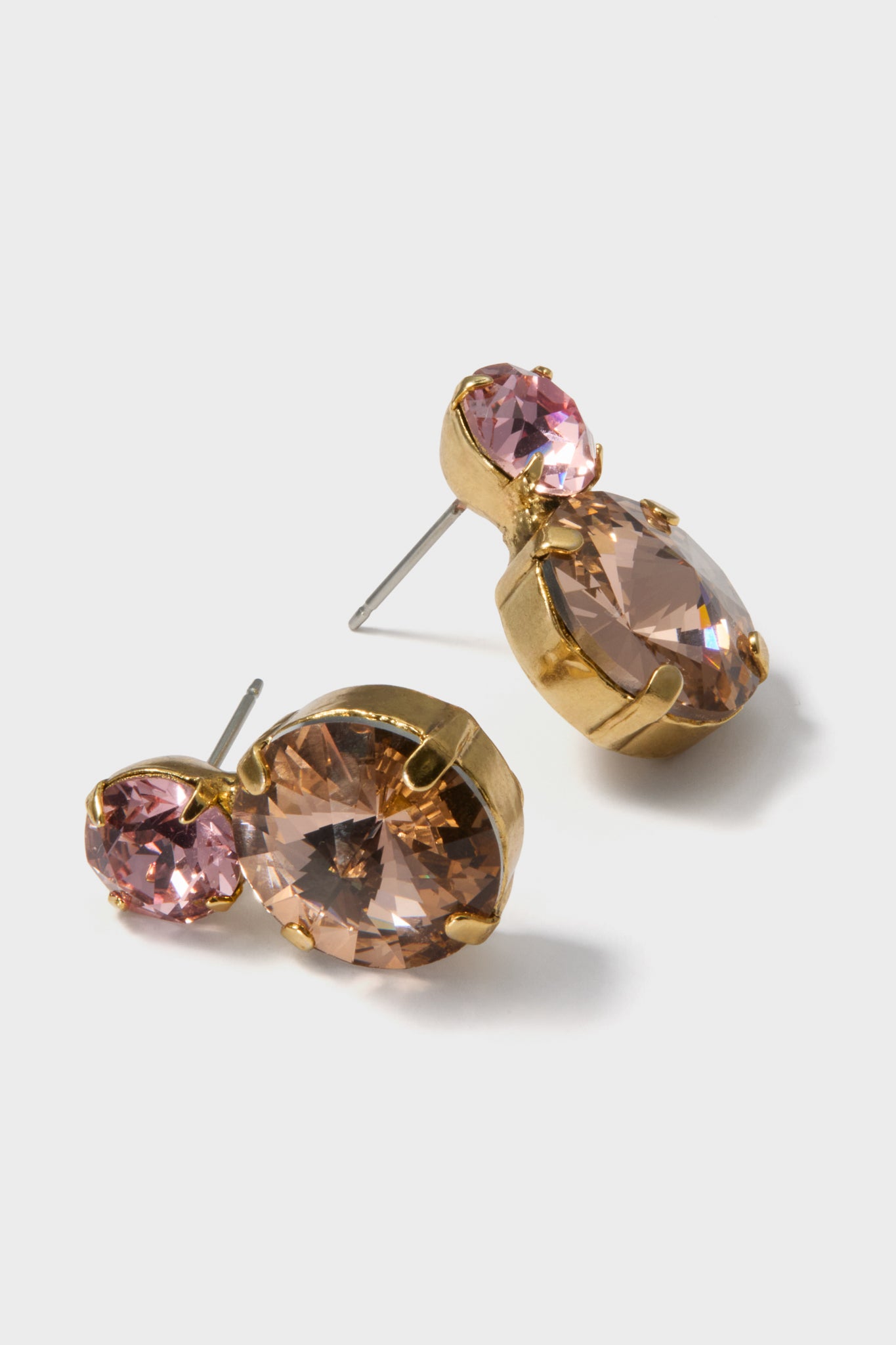 Classic Rose Quartz Myrla Earrings featuring champagne and pink crystals in a gold-tone bezel, exude effortless elegance and fun sparkle, perfect for high-end occasions.