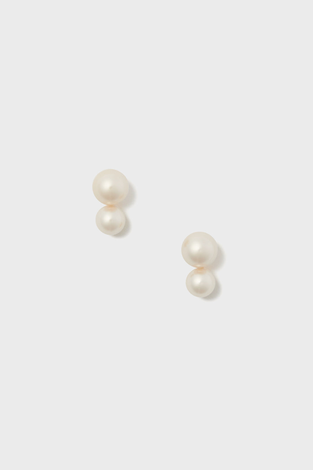 Jennifer Behr double pearl stud earrings feature two round white pearls stacked vertically on each earring—an elegant, timeless choice for lovers of luxury accessories and handmade jewelry.