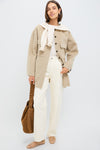 Woman wearing Beige Chine Florian Coat, an oversized, classic wool-blend shacket, layered effortlessly with high-waisted jeans and a suede tote, embodying high-end, fun, and chic style.