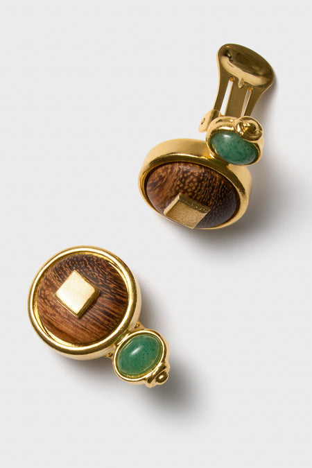Classic and effortless Oak and Green Earrings featuring gold-tone frames, domed wooden discs, and green stones, offering a fun, high-end touch to any outfit.