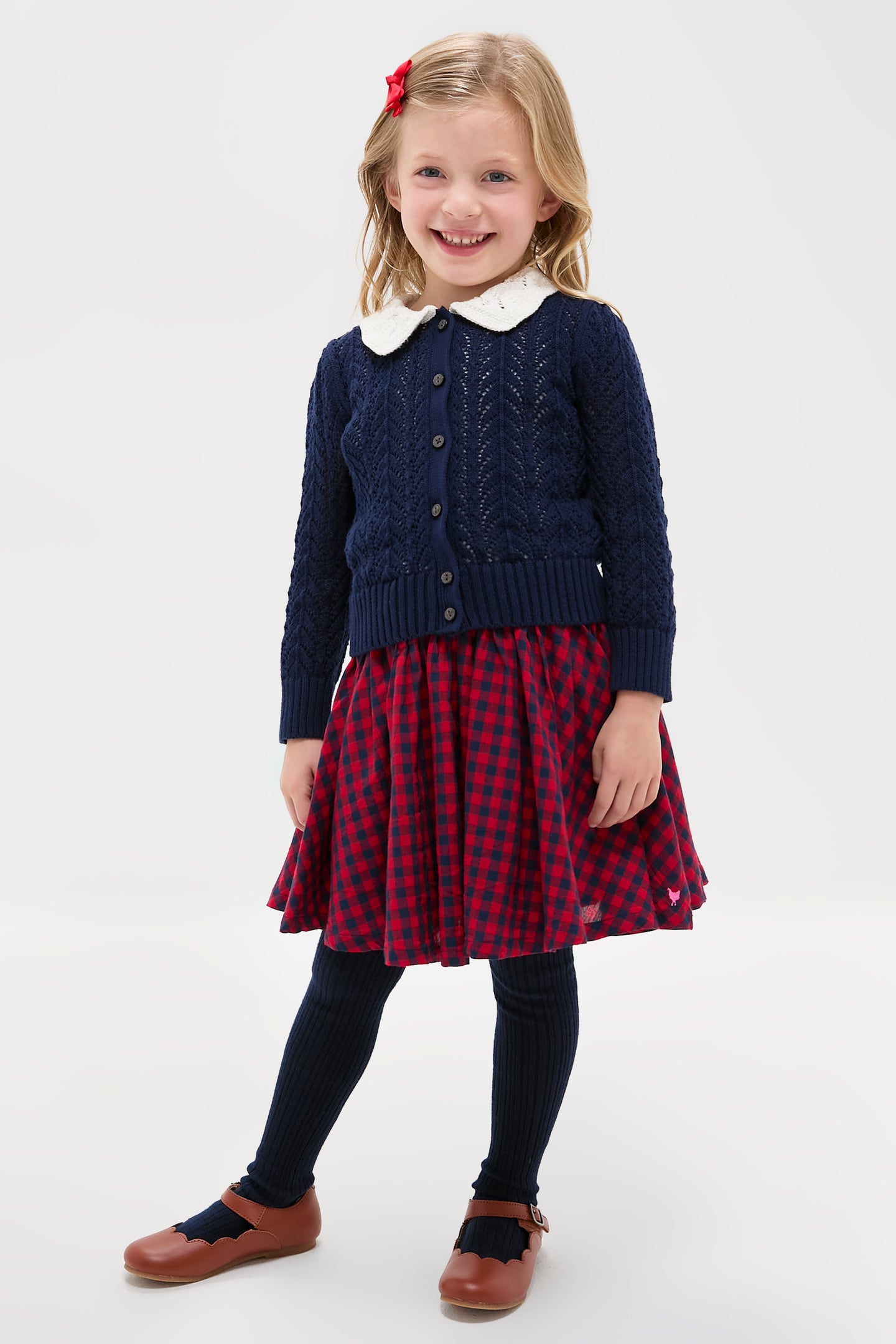 Preschool girl in a classic, effortless Red Blue Check Gianna Skirt, featuring a fun ruffle trim and elastic waist, embodying high-end style and playful elegance.