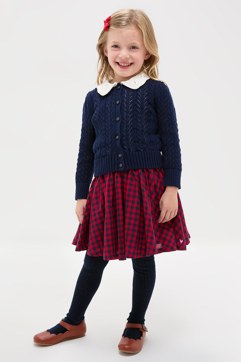 Preschool girl in a classic, effortless Red Blue Check Gianna Skirt, featuring a fun ruffle trim and elastic waist, embodying high-end style and playful elegance.