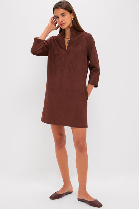 Model wearing the Ganache Vegan Suede Clifton Dress; classic, effortless design with a V-neckline, three-quarter sleeves, and pockets, paired with brown flats and gold necklace.