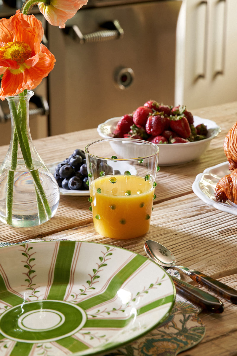 Green Dots Party Tumbler (Set of 6) by Zafferano, showcasing classic, effortless style with raised green dots, elegantly complements a high-end, fun breakfast table scene.