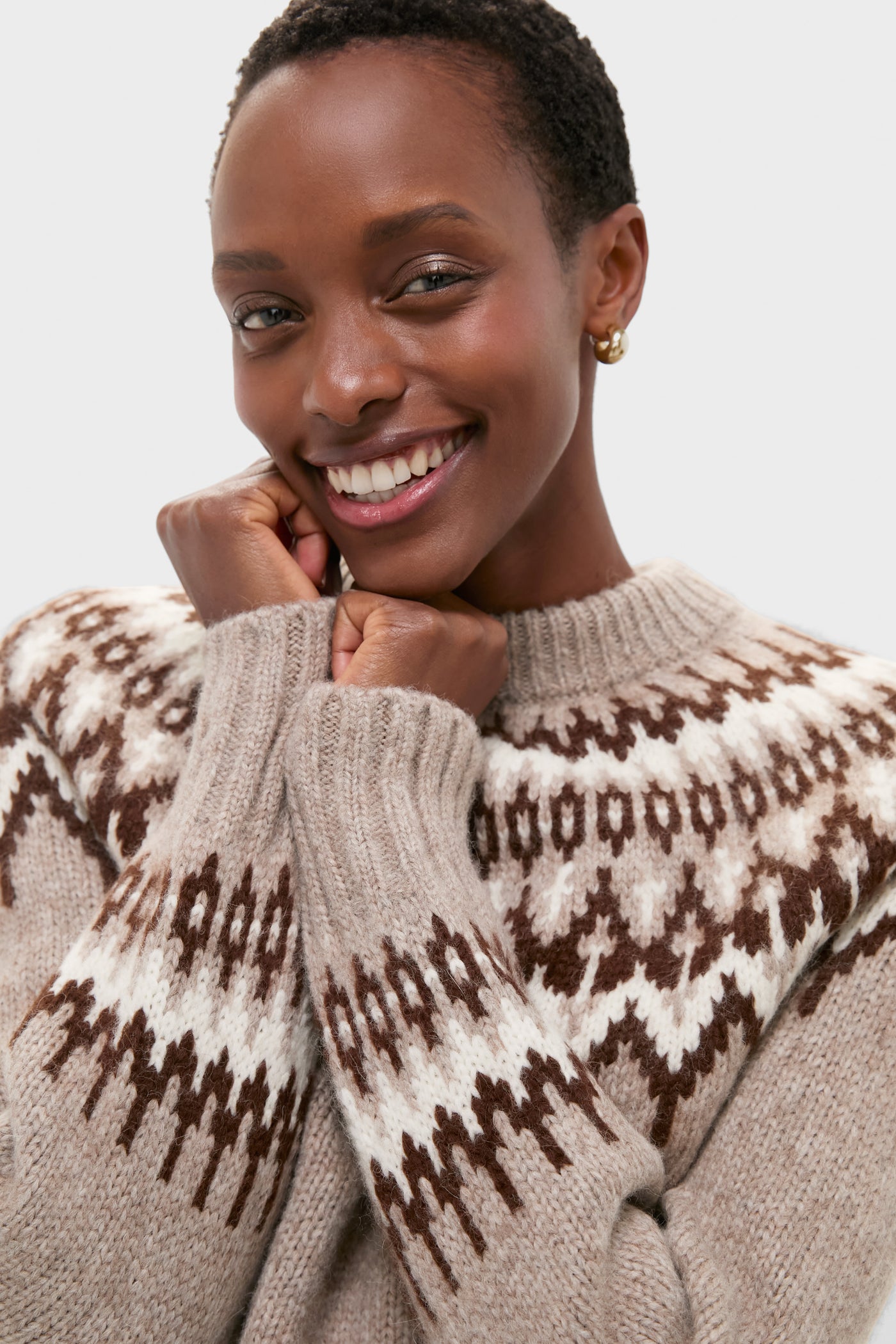Young person wearing a classic, effortless Taupe Fairisle Thatcher Crewneck, showcasing a fun, high-end geometric pattern, embodying cozy elegance with a relaxed fit.