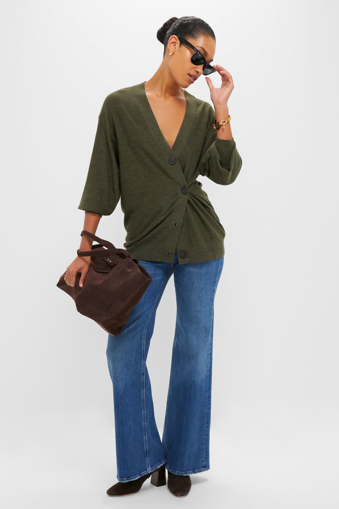 Model in Olive Drippy Tissue Cardigan, styled effortlessly with high-waisted jeans and dark suede accessories, embodies Tuckernuck's classic, fun, and high-end transitional fashion.