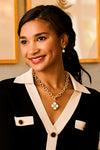 Young woman wearing Pearl Berry Drop Stud Earrings, showcasing their classic, effortless shimmer. These fun, high-end earrings enhance her confident, stylish look with a playful touch.
