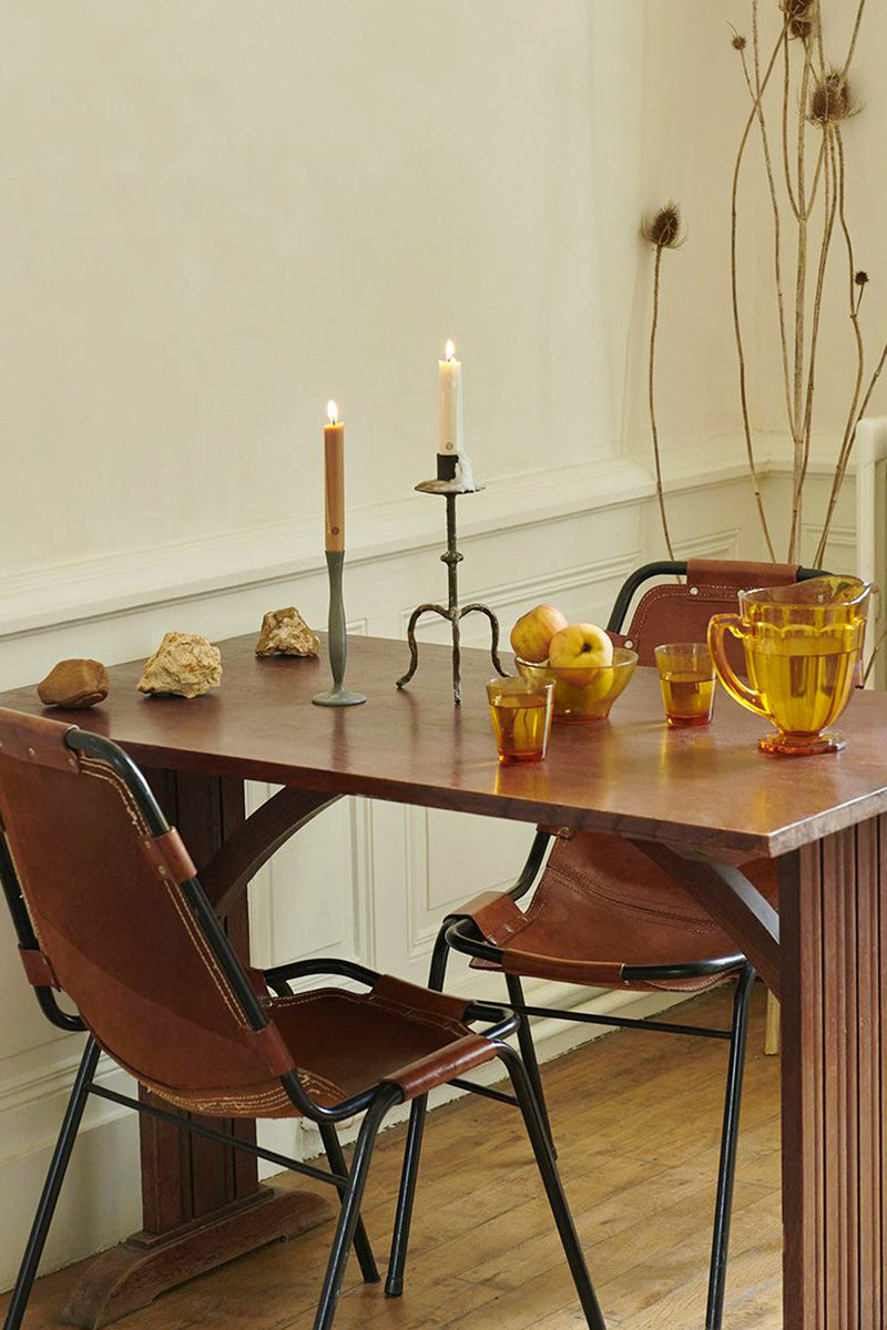 Cedar Scented Taper Candles add a classic, high-end touch to this rustic dining setup, effortlessly combining elegance with fun elements like unique candlesticks and decor.
