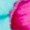 A close-up of a bright pink object with a blurred teal hue.