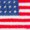 The image shows the American flag, featuring 50 white stars on a blue field and 13 horizontal red and white stripes.
