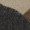 A close-up image reveals a textured black surface beside a beige and brown area, with details blurred by pixelation.
