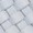 Close-up view of light gray rectangular paving stones arranged in a herringbone pattern, highlighting the texture and detail of the surface.