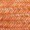 Close-up of a textured orange and brown woven surface, displaying a repeating pattern.