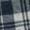 Close-up of a soft fabric featuring a classic black, white, and gray plaid pattern.