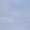 A pale blue sky with faint, wispy clouds drifting gently across the horizon.
