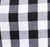 Close-up of black, white, and gray plaid fabric with a large checkered pattern, highlighting its classic style.