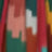 A blurred, abstract pattern with red, green, orange, yellow, pink, and white block shapes.