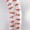 A tall spiral stack of white and red capsules is arranged vertically, creating a striking visual.