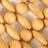 Close-up of a wooden bead seat cover showing alternating round and oval beads on a fabric background.
