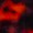 A blurry, pixelated red and black abstract image with no distinct shapes or objects, featuring a digital texture.