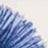 Close-up of blue bristles or fibers fanned out, showcasing vibrant texture and detail.