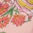 Close-up of a fabric in shades of pink, orange, green, and yellow with a charming floral pattern.