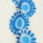 Blurry image of three blue circular shapes with radiating lines, arranged vertically on a light background.