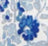 A close-up of a floral pattern featuring blue and light blue flowers and leaves on a white background.