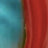 A close-up of an abstract image featuring a vivid blend of blue on the left and red on the right, separated by a thin, irregular greenish line.