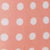 A peach hue decorated with evenly spaced white polka dots.