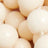 Cream-colored beads with a smooth, round finish are elegantly strung together in this close-up view.