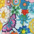 A close-up of a colorful, abstract floral pattern with various flowers and a pink and blue butterfly.