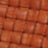 Close-up of a textured, reddish-brown, woven textile with a grid-like pattern.